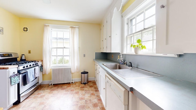 kitchen with radiator heating unit, white cabinets, white dishwasher, and stainless steel range with gas cooktop