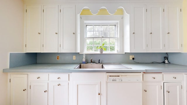 kitchen with dishwasher, sink, and white cabinets