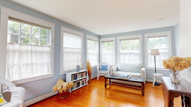 sunroom / solarium featuring a baseboard heating unit