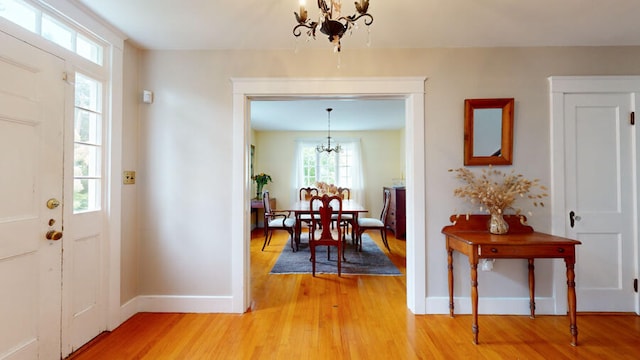 foyer entrance with a chandelier and hardwood / wood-style flooring