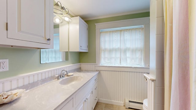 bathroom with vanity, crown molding, a baseboard radiator, toilet, and tile patterned floors