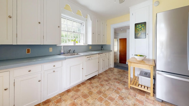 kitchen with white cabinets, stainless steel refrigerator, sink, and dishwasher