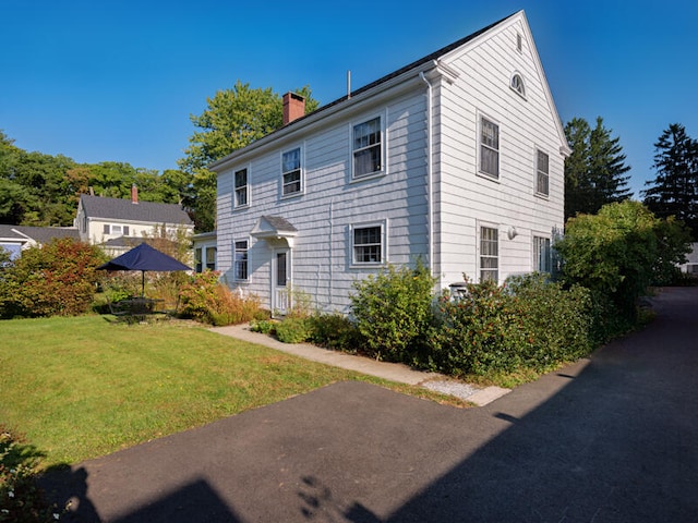 colonial-style house with a front lawn