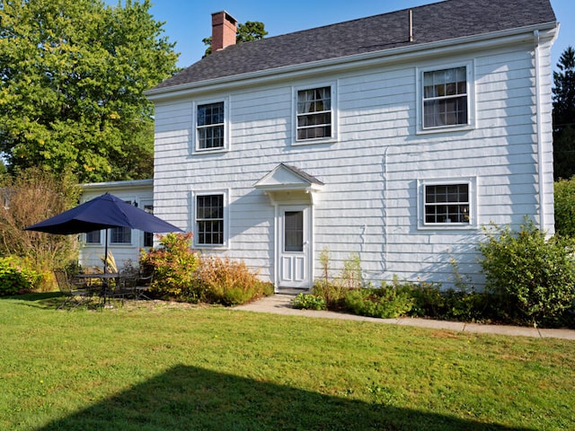 colonial inspired home with a front yard