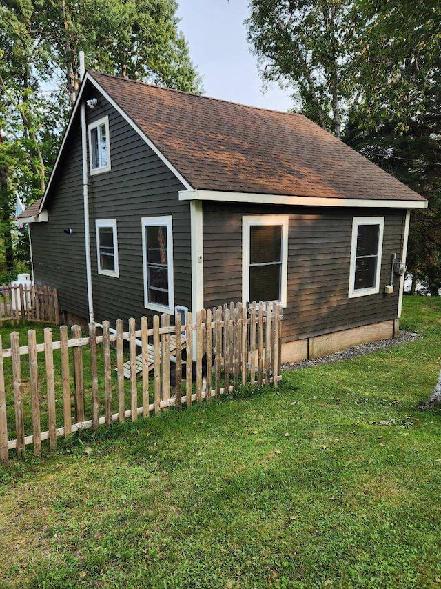 rear view of house featuring a yard