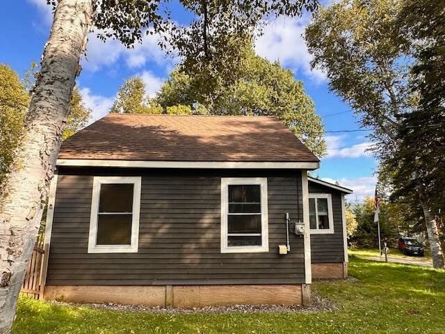 view of side of property with a lawn