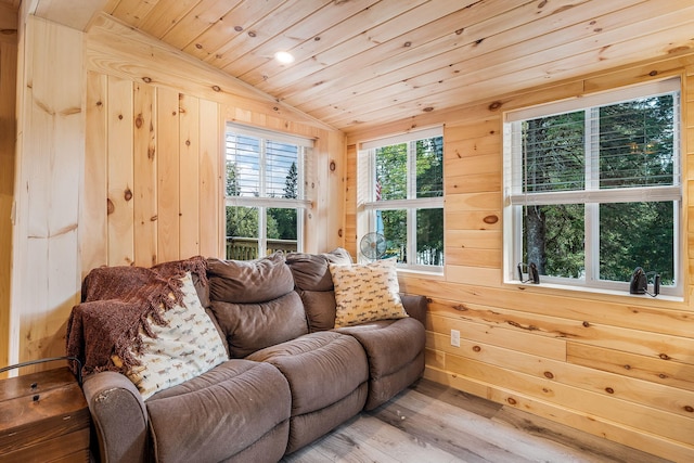 living room featuring wooden ceiling, lofted ceiling, wood walls, and hardwood / wood-style floors