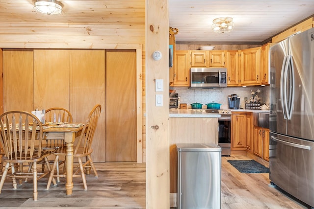 kitchen with wood ceiling, light hardwood / wood-style flooring, stainless steel appliances, decorative backsplash, and light brown cabinetry