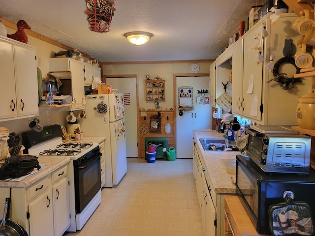 458 Lambert Rd, Brewer, ME 04412 - kitchen featuring range with gas stovetop, light countertops, black microwave, a textured ceiling, and light floors