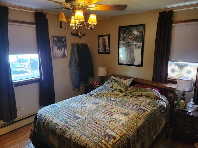 458 Lambert Rd, Brewer, ME 04412 - bedroom featuring a baseboard heating unit and wood finished floors