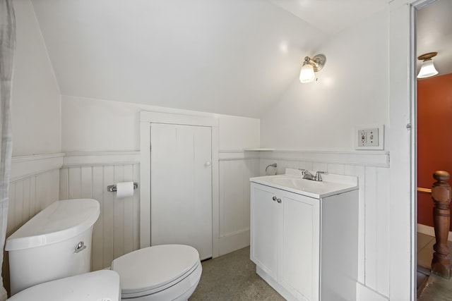 bathroom with vanity, toilet, and vaulted ceiling