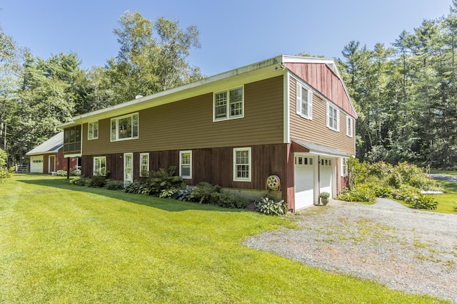 51 Malone Rd, Westport Island, ME 04578 - colonial inspired home featuring gravel driveway, a front yard, and a garage
