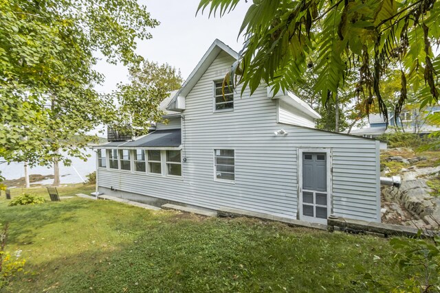 rear view of property with a yard