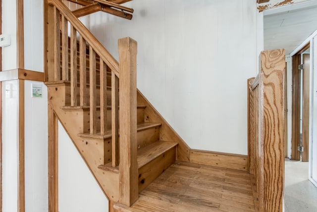 stairway with hardwood / wood-style flooring