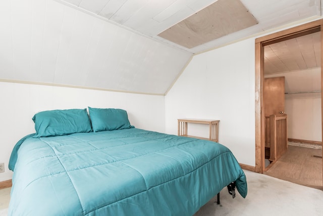 carpeted bedroom featuring lofted ceiling, wood walls, and wooden ceiling