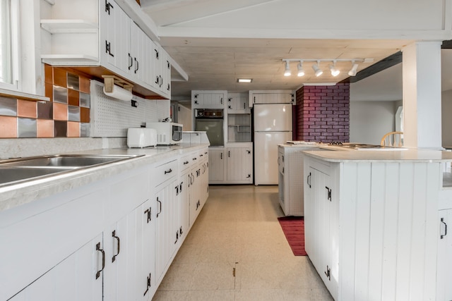 kitchen with white appliances and white cabinetry