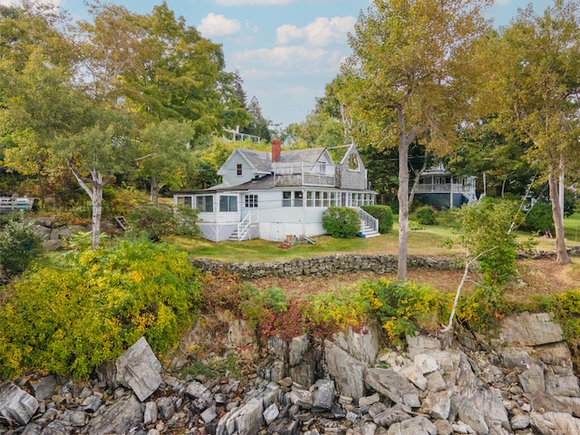 rear view of property featuring a wooden deck