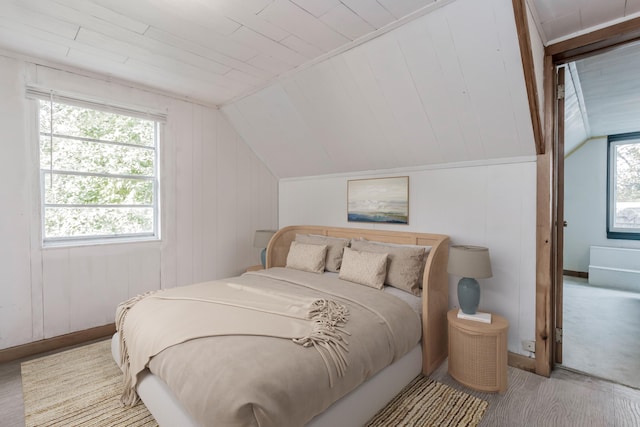 carpeted bedroom featuring lofted ceiling and wood ceiling