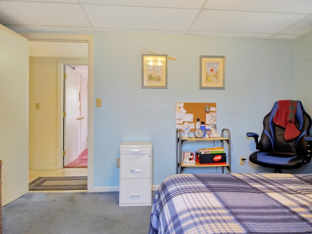 carpeted bedroom with a paneled ceiling