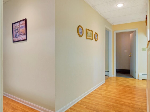 hallway with a baseboard radiator and wood-type flooring