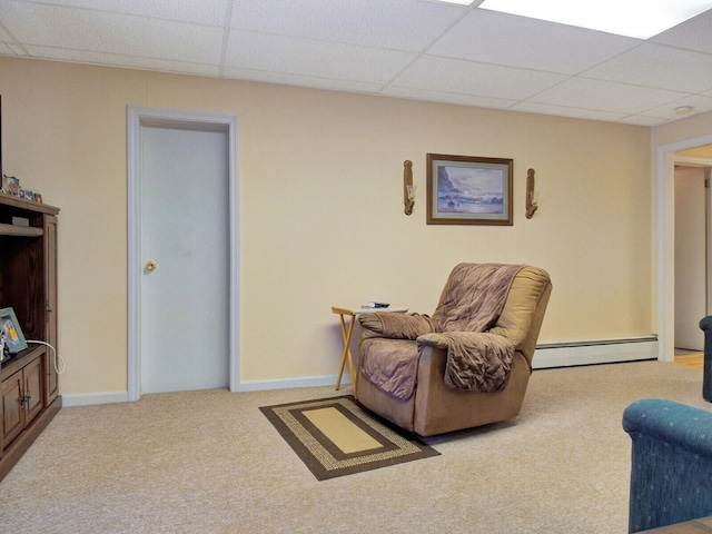 sitting room with a baseboard heating unit, carpet, and a drop ceiling