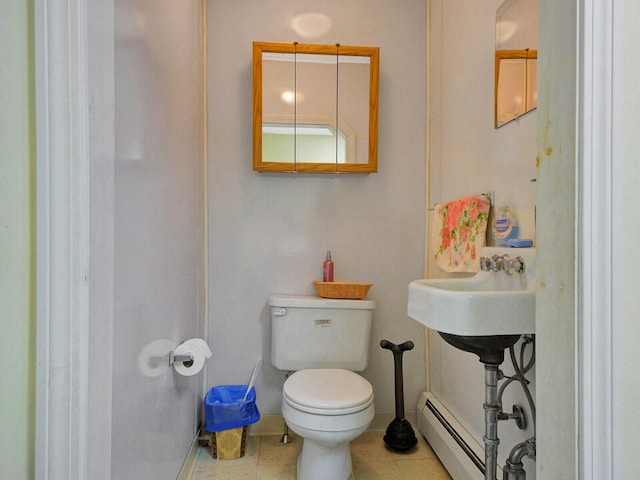 bathroom with tile patterned flooring, a baseboard radiator, and toilet