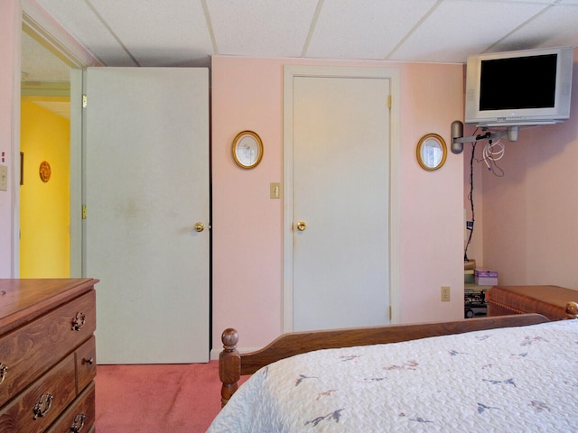 carpeted bedroom featuring a paneled ceiling