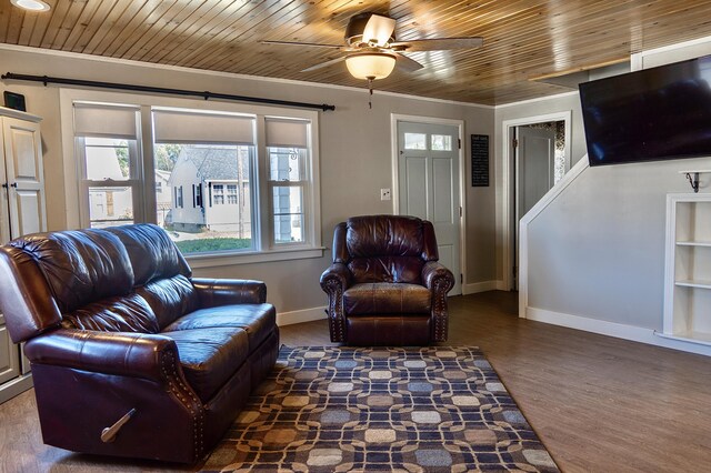 living room featuring crown molding, dark wood-type flooring, ceiling fan, and wooden ceiling