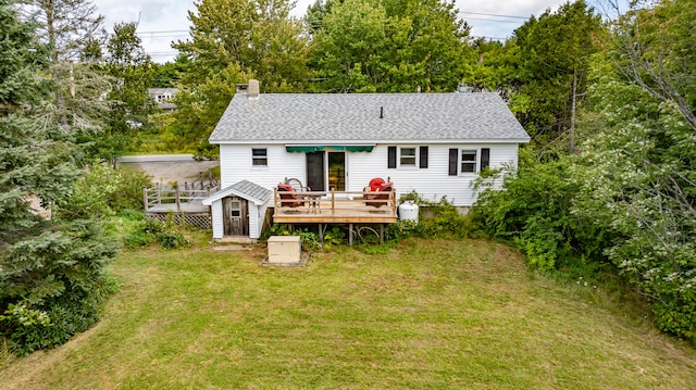 rear view of house featuring a yard and a wooden deck