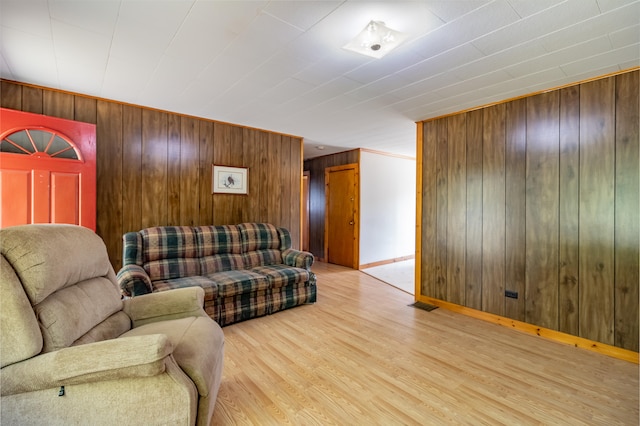 living room featuring wooden walls and light wood-type flooring