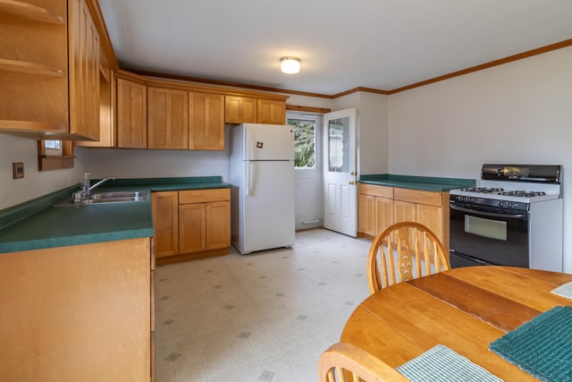 kitchen with crown molding, white fridge, sink, and black range with gas cooktop