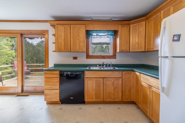 kitchen with white fridge, sink, and black dishwasher