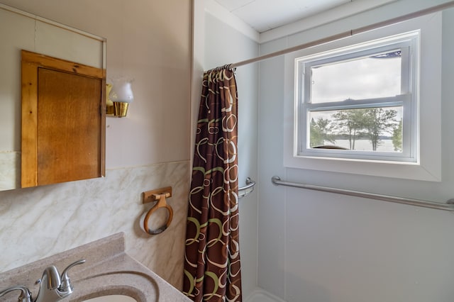 bathroom with vanity and curtained shower