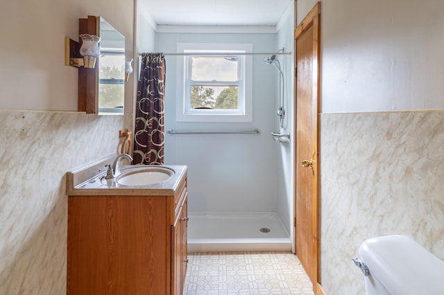 bathroom with vanity, curtained shower, and toilet