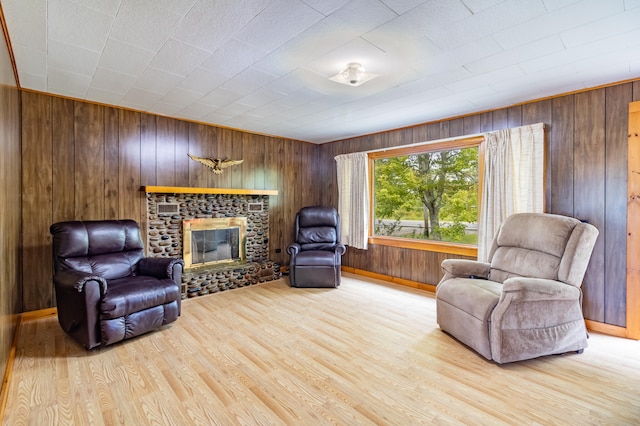 living area featuring wooden walls and light hardwood / wood-style flooring