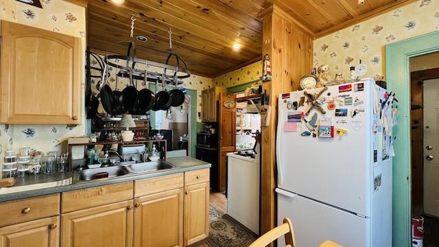 kitchen with wallpapered walls, wood ceiling, freestanding refrigerator, stove, and a sink