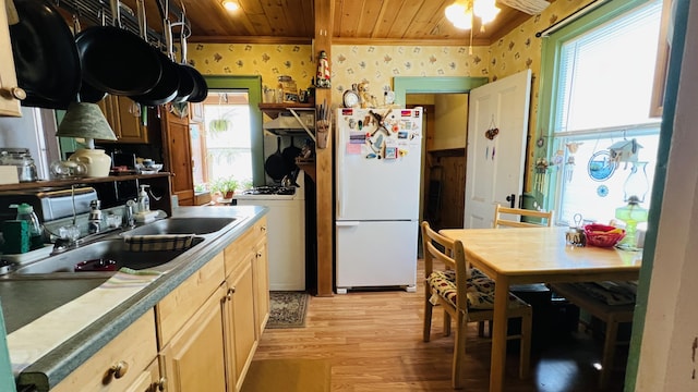 kitchen with wallpapered walls, freestanding refrigerator, ornamental molding, wood ceiling, and light wood-style floors