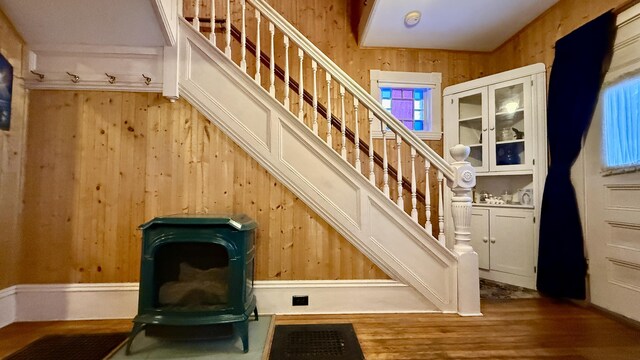 stairway featuring wooden walls and wood finished floors