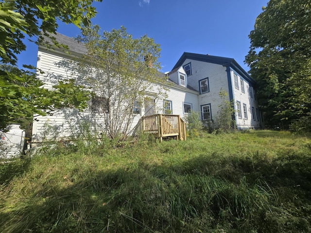 back of house with a wooden deck