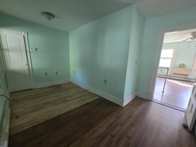 unfurnished room featuring baseboards, ceiling fan, and wood finished floors