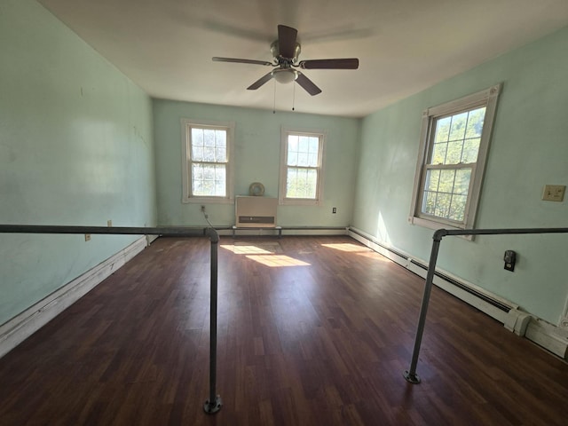 spare room featuring a ceiling fan, wood finished floors, and baseboards