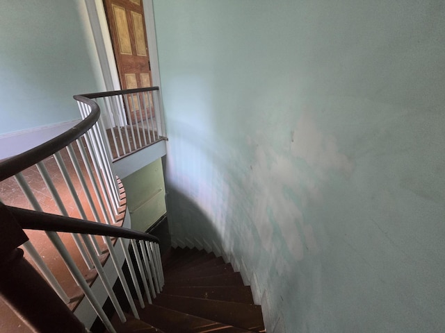 stairway featuring wood finished floors