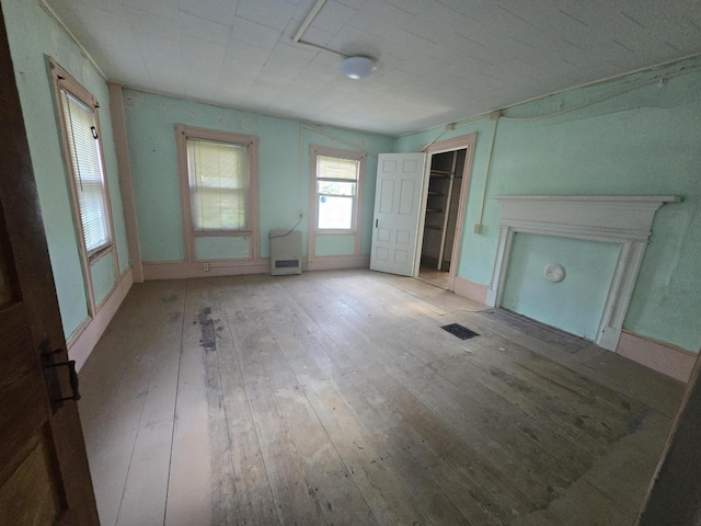 unfurnished living room with hardwood / wood-style flooring