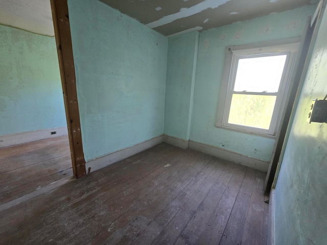 unfurnished room with hardwood / wood-style flooring