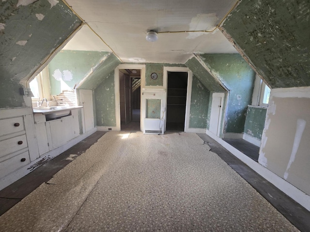 bonus room featuring a sink and lofted ceiling