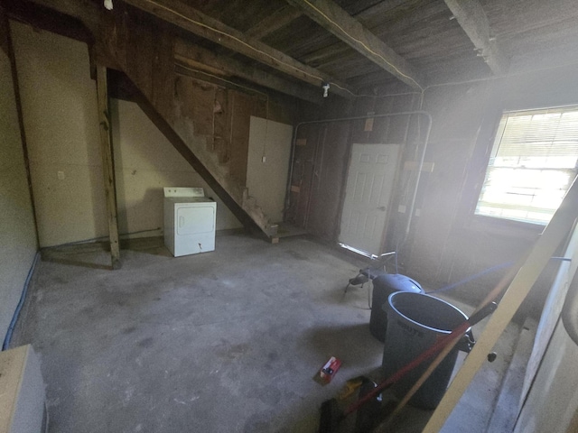 below grade area featuring stairs and washer / dryer