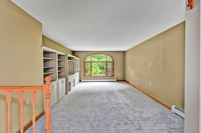 unfurnished living room with a baseboard heating unit, light colored carpet, and a textured ceiling