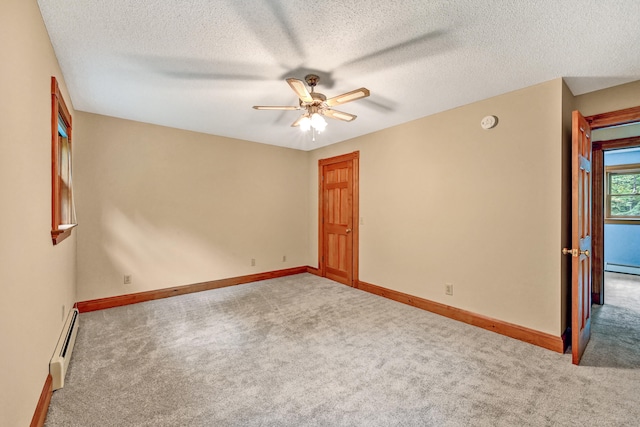 unfurnished room with carpet flooring, ceiling fan, baseboard heating, and a textured ceiling