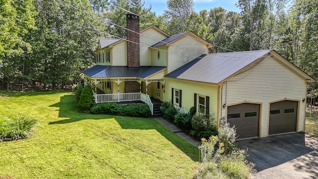 view of front of home featuring a garage, a front lawn, and covered porch