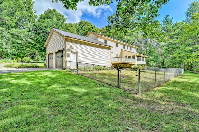 view of side of property featuring a yard and a garage